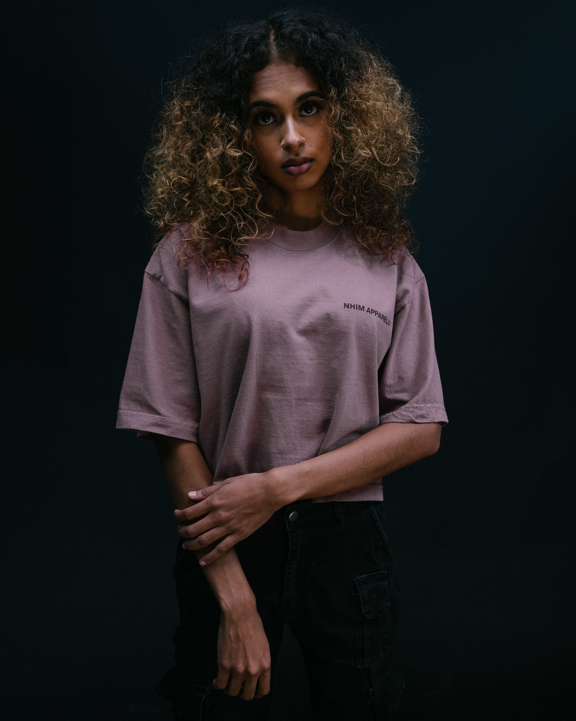 God Is Everywhere crop tee thistle color model with black background standing pic from front by NHIM Apparel christian clothing brand