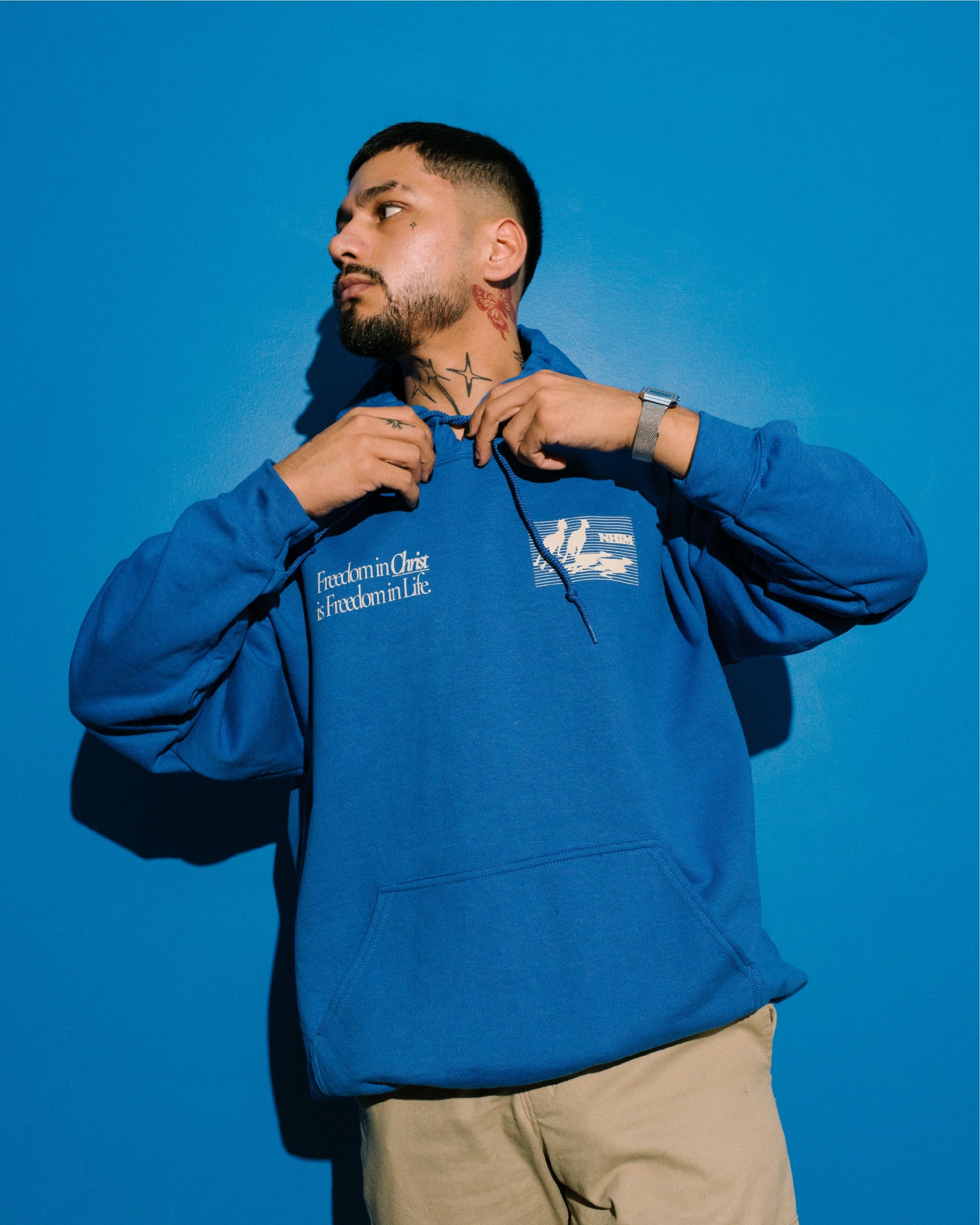 FREEDOM IN CHRIST HOODIE (ROYAL) on a model by NHIM Apparel Christian clothing brand