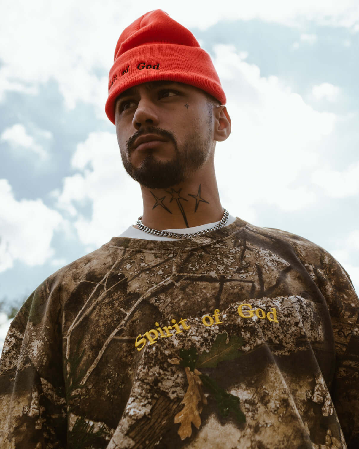 Spirit of God camo shirt and orange hat on a model outside by NHIM Apparel Christian clothing brand