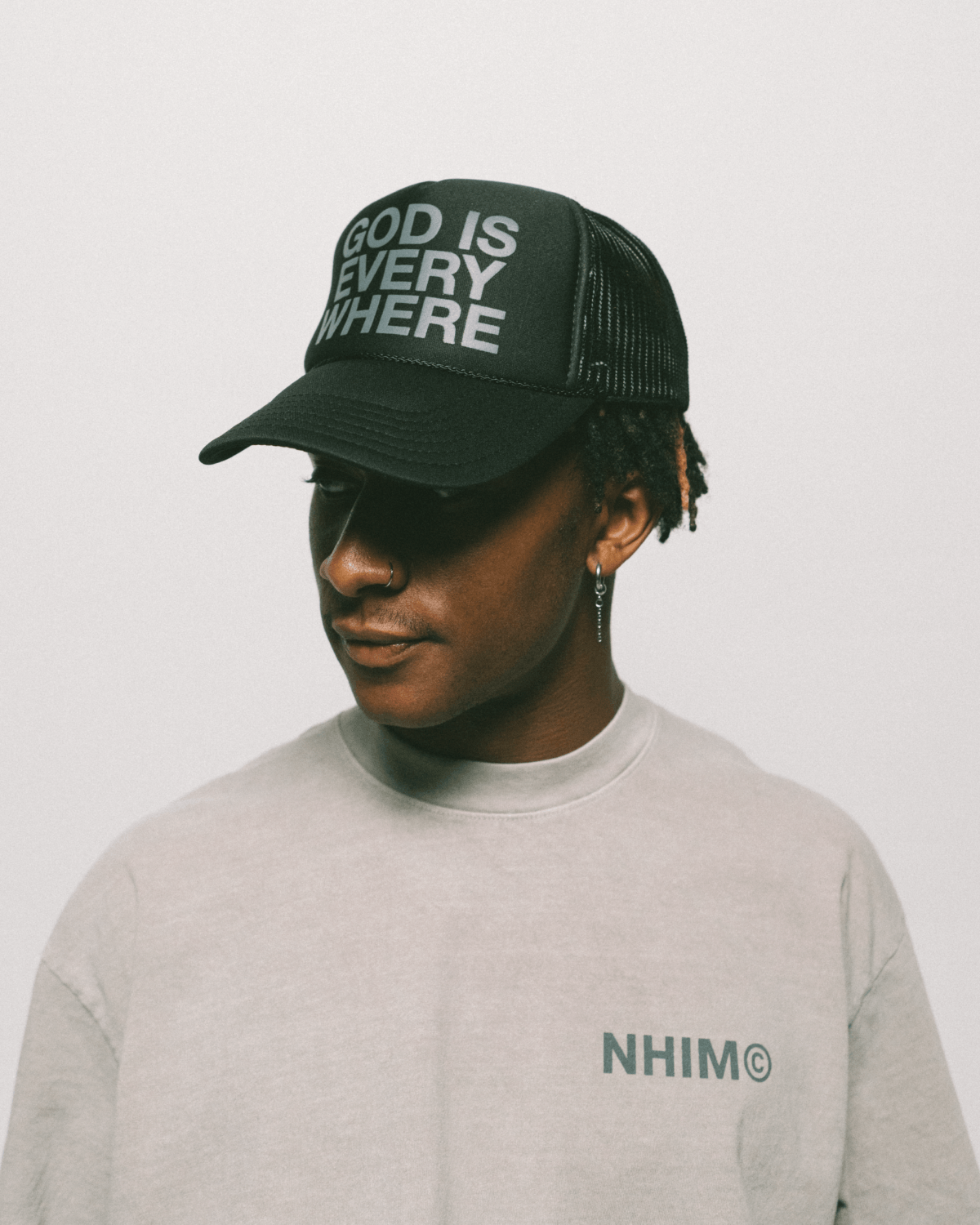 GOD IS EVERYWHERE PREMIUM CHRISTIAN APPAREL COLLECTION. Black trucker hat and cement shirt by NHIM APPAREL