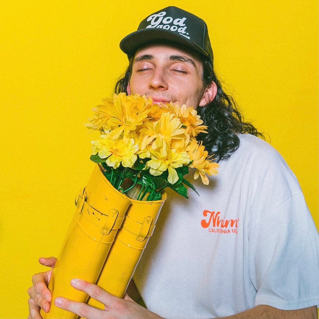 Christian hat. God is good all the time. Black trucker hat. NHiM Apparel. Happy guy smelling flowers