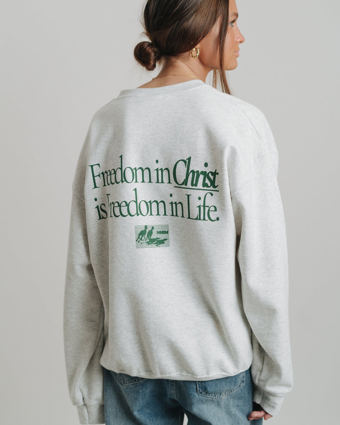 Freedom in Christ Crewneck Sweatshirt on a model by NHIM Apparel Christian clothing brand