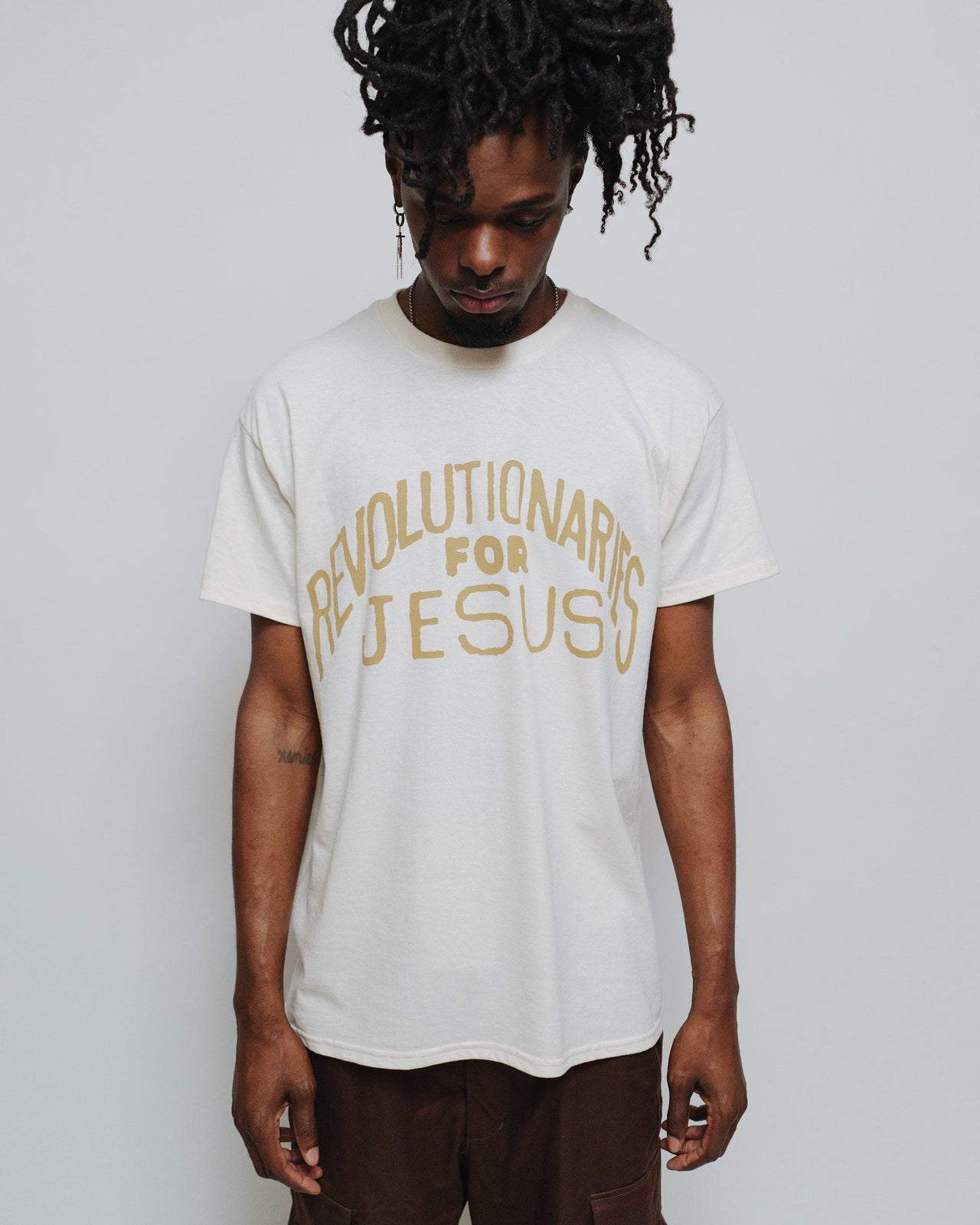 "Revolutionaries for Jesus" Christian T-Shirt in natural for the modern day Jesus People movement. New take on a vintage classic. Made in the USA by NHIM Apparel Christian clothing brand