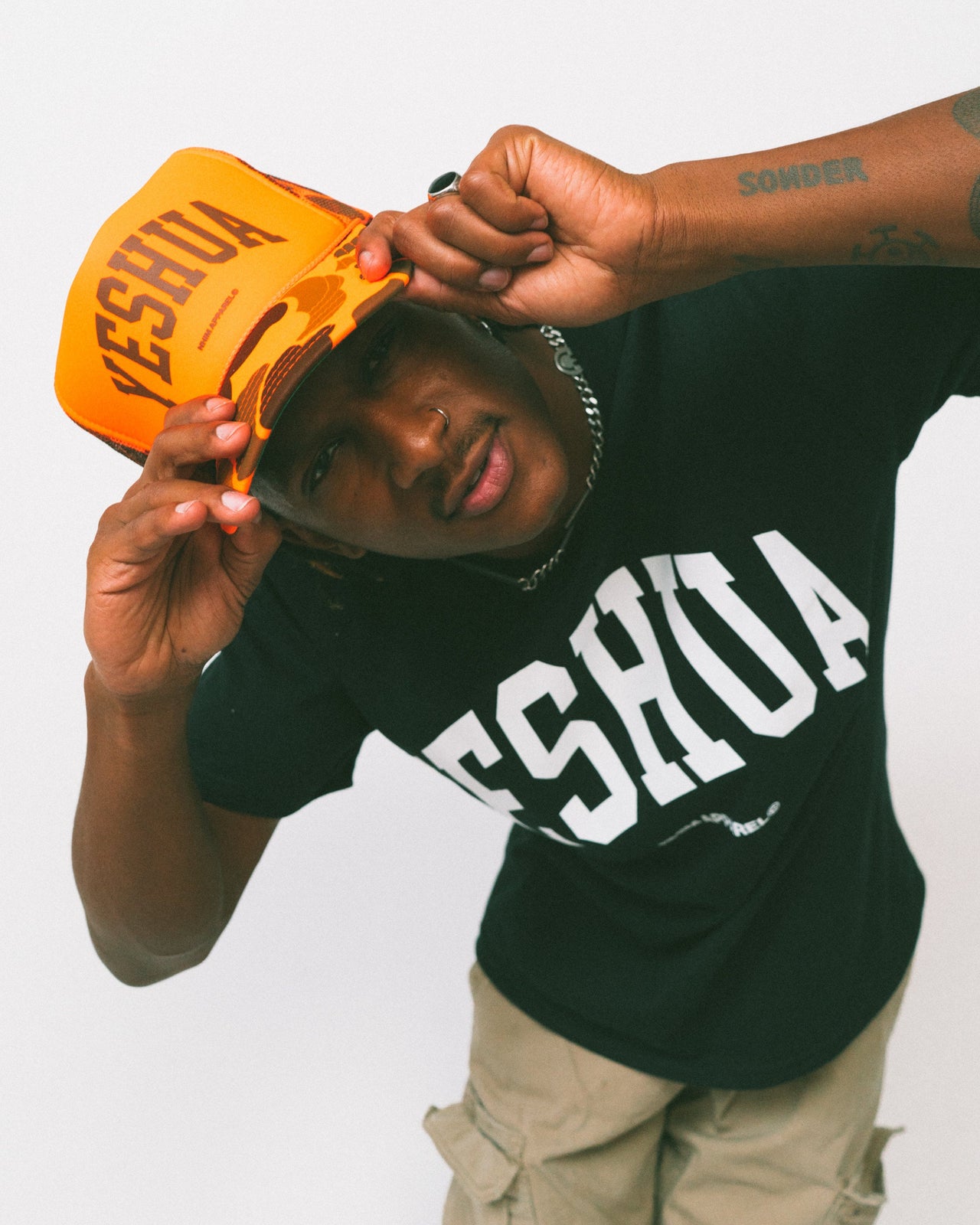 YESHUA Christian trucker hat from NHIM Apparel Christian Clothing Brand, hunter orange camo hat with brown writing