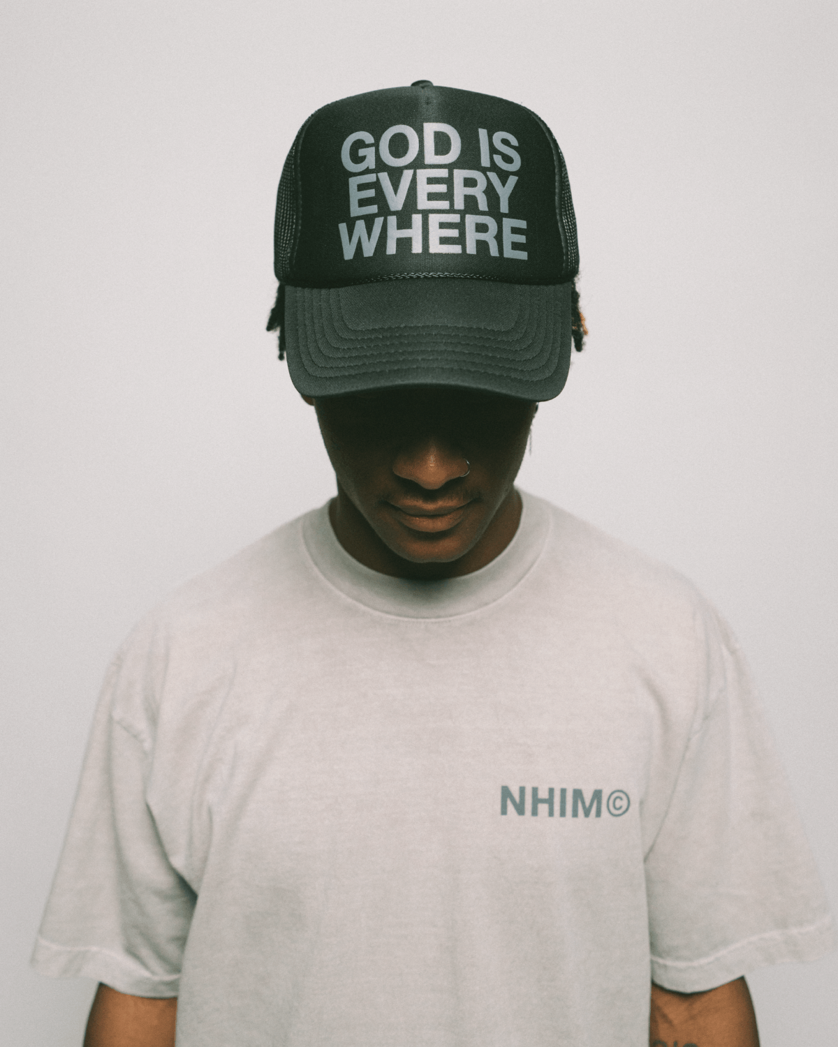 GOD IS EVERYWHERE PREMIUM CHRISTIAN APPAREL COLLECTION. Black trucker hat and cement shirt by NHIM APPAREL