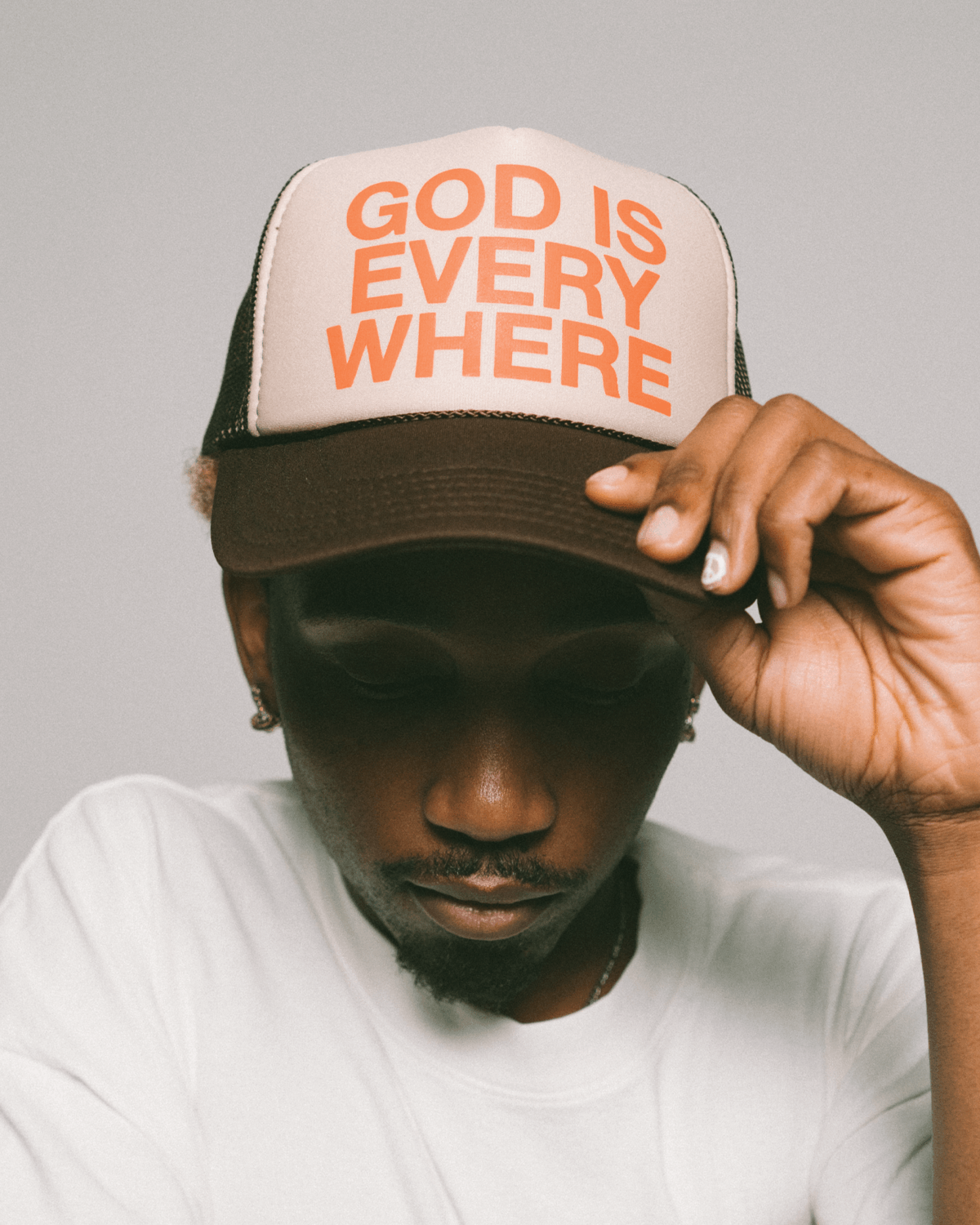 GOD IS EVERYWHERE Trucker hat brown and tan with orange writing. Christian hat by NHIM APPAREL