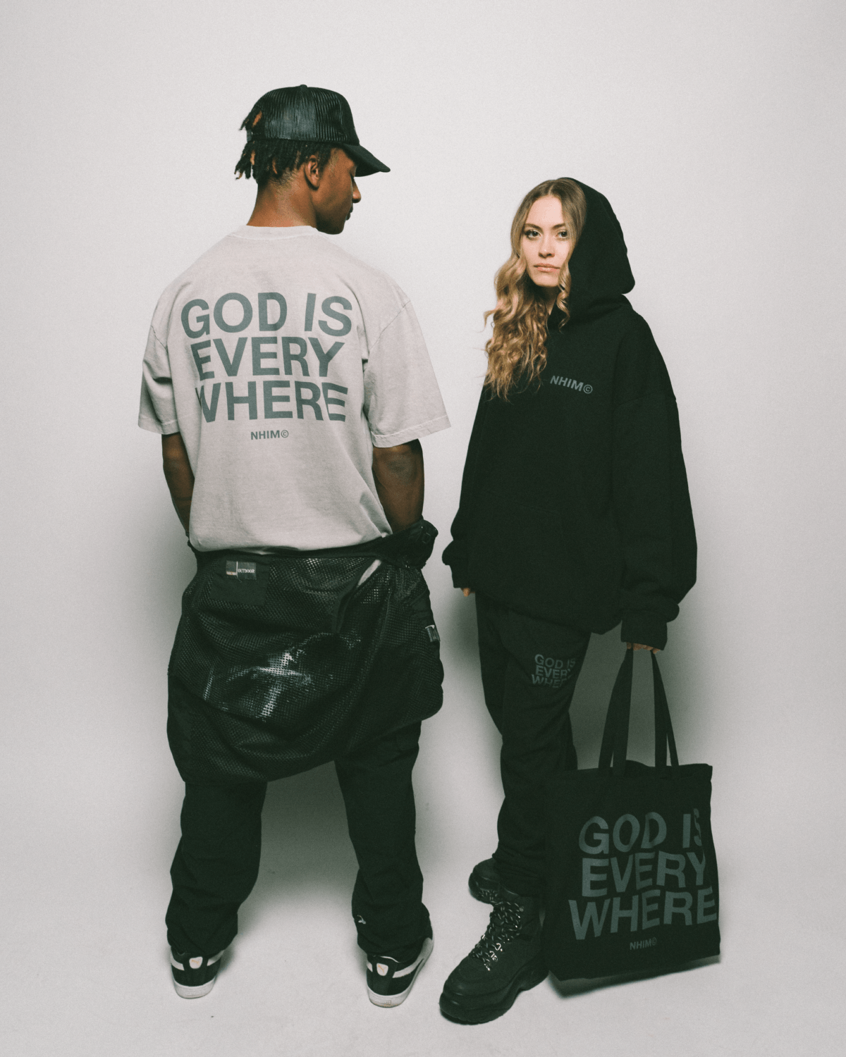 Christian t shirt. God is Everywhere. Made in USA. NHiM Apparel Christian Clothing Company. God is everywhere dark silver t shirt and black hoodie and black tote bag.